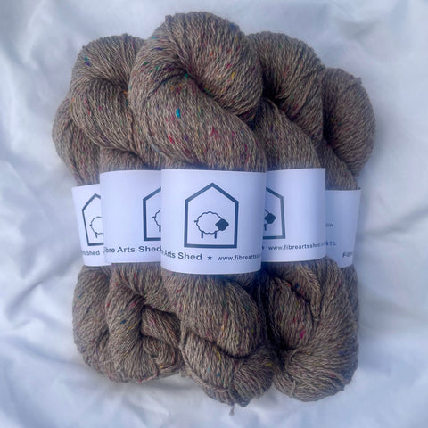Skeins of brown yarn with labels on a white background